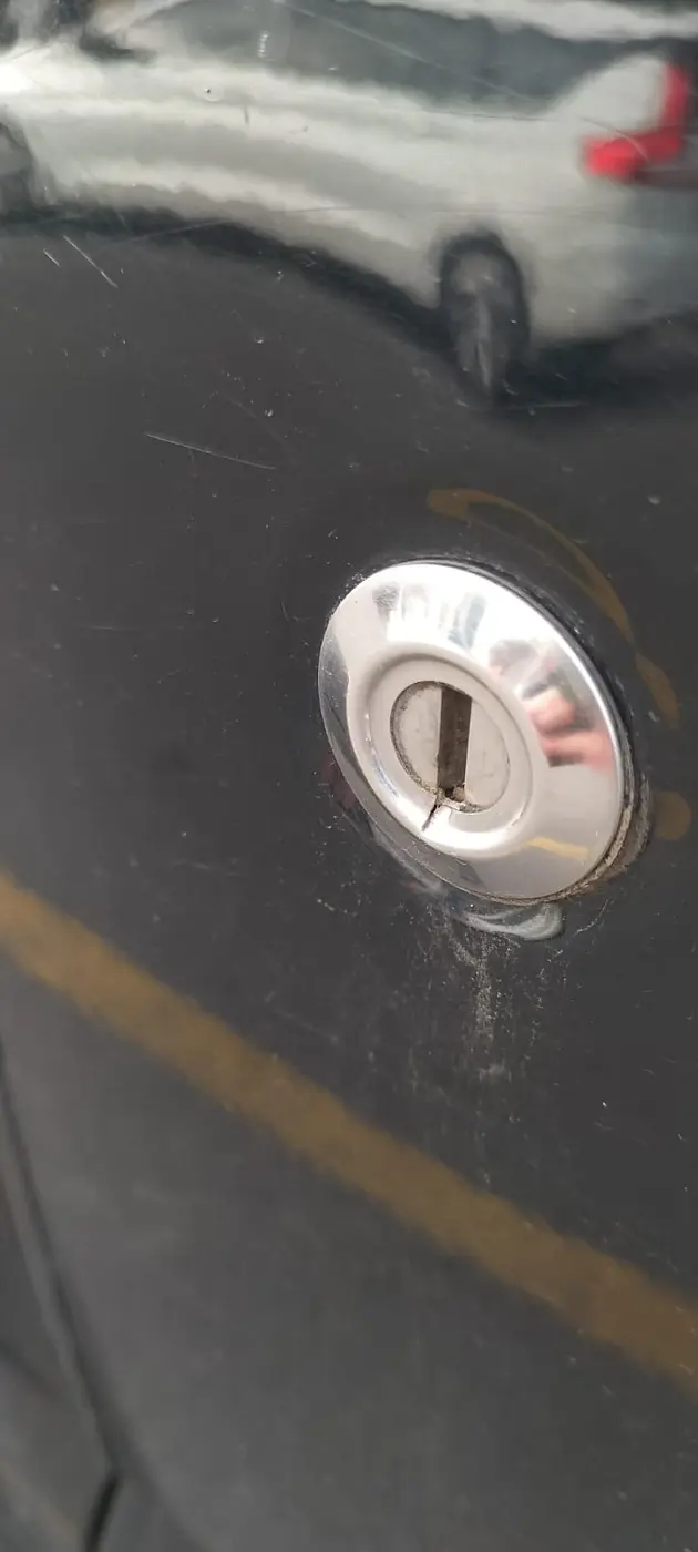 Damaged factory lock on a black Suzuki Jimny
